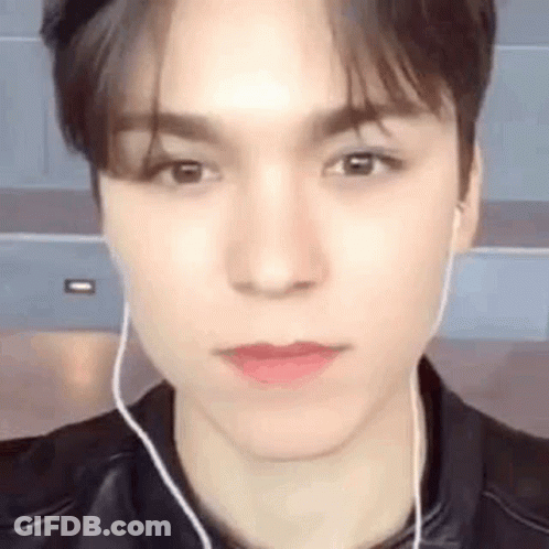 A Close Up Of A Young Man Wearing Earphones And A Leather Jacket . GIF