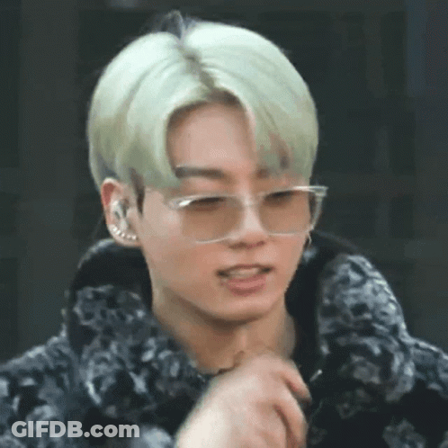 A Close Up Of A Young Man Wearing Glasses And A Fur Coat . GIF