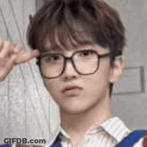 A Close Up Of A Young Man Wearing Glasses And Making A Funny Face . GIF