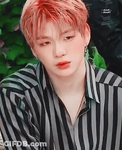 A Close Up Of A Young Man With Red Hair Wearing A Striped Shirt . GIF