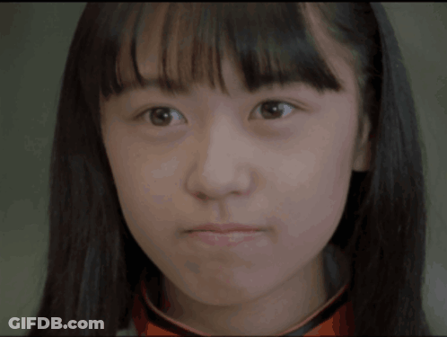 A Close Up Of A Young Woman 'S Face With A Serious Look On Her Face GIF
