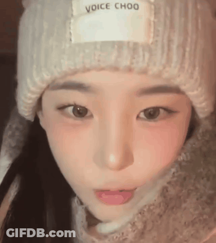 A Close Up Of A Young Woman Wearing A Hat And Scarf . GIF