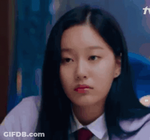 A Close Up Of A Young Woman Wearing A White Shirt And Red Tie . GIF