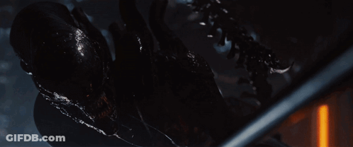 A Close Up Of An Alien With Its Mouth Open And Sharp Teeth GIF