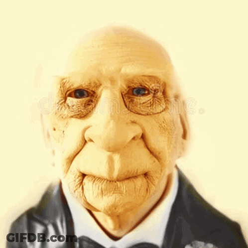 A Close Up Of An Elderly Man 'S Face Wearing A Suit And Bow Tie GIF