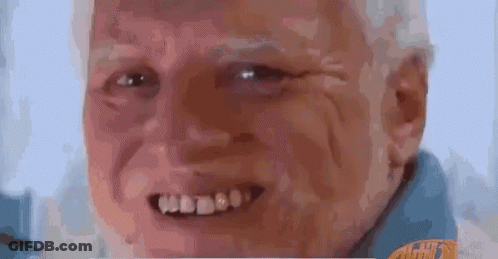 A Close Up Of An Elderly Man 'S Face With A Beard And A Smile . GIF