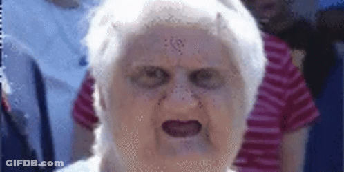 A Close Up Of An Elderly Woman 'S Face With A Devil 'S Face On It . GIF