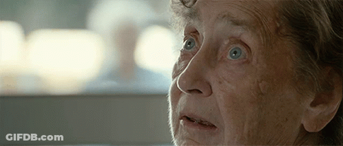 A Close Up Of An Elderly Woman 'S Face With Blue Eyes GIF