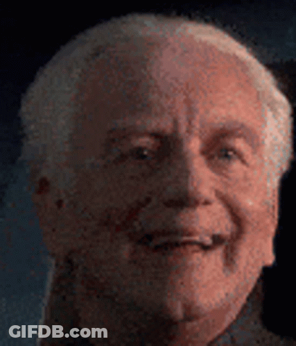 A Close Up Of An Older Man 'S Face With A Blurred Background . GIF