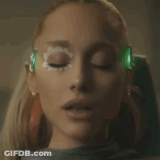 A Close Up Of An Older Woman 'S Face With Her Eyes Closed And Her Hand On Her Neck . GIF