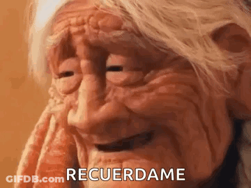 A Close Up Of An Older Woman 'S Face With The Words `` Recuerdame '' Written On It . GIF