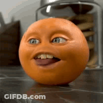 A Close Up Of An Orange With A Funny Face GIF