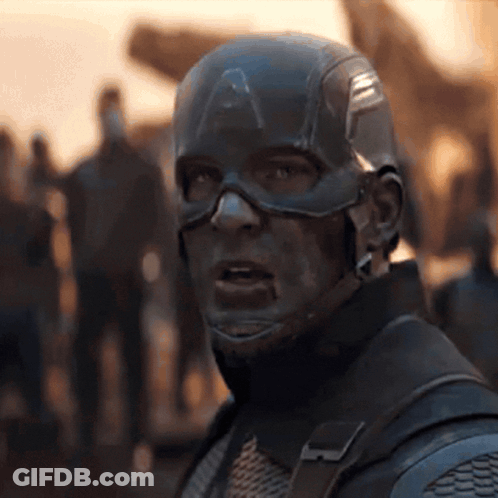 A Close Up Of Captain America 'S Face With A Crowd Of People In The Background GIF