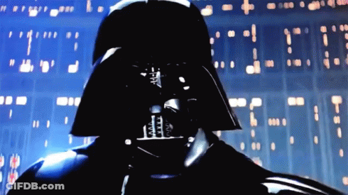 A Close Up Of Darth Vader 'S Face In Front Of A Wall GIF
