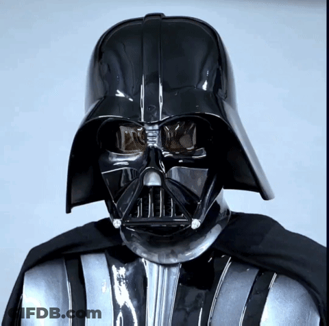 A Close Up Of Darth Vader 'S Face With A Black Helmet On GIF