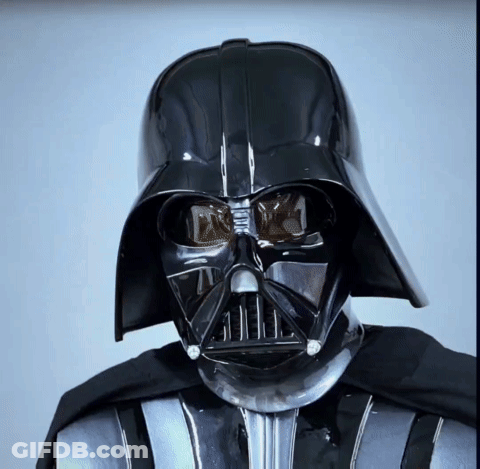 A Close Up Of Darth Vader 'S Face With A Black Helmet GIF