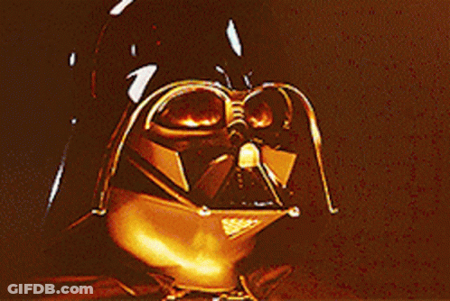 A Close Up Of Darth Vader 'S Face With A Glowing Eye GIF