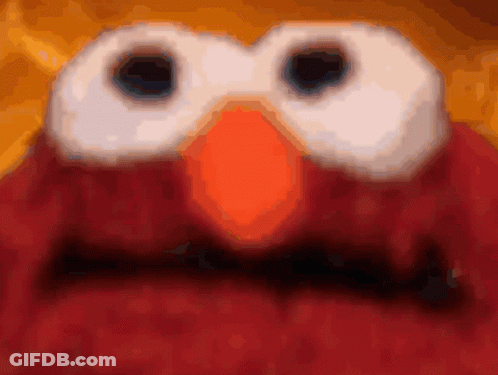 A Close Up Of Elmo 'S Face With A Blurred Background GIF