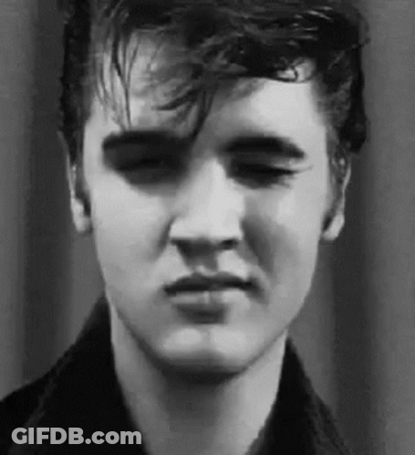 A Close Up Of Elvis Presley 'S Face In A Black And White Photo With His Eyes Closed . GIF