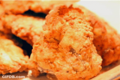 A Close Up Of Fried Chicken Pieces On A Plate GIF