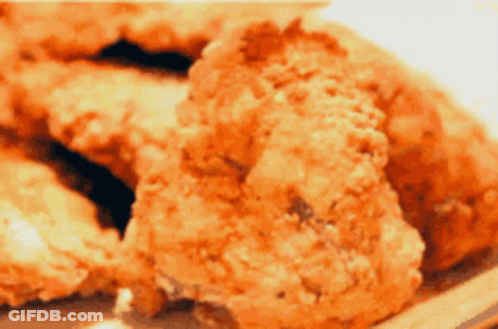 A Close Up Of Fried Chicken Pieces On A Plate GIF