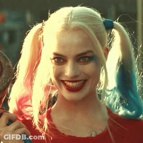 A Close Up Of Harley Quinn 'S Face With Pigtails GIF