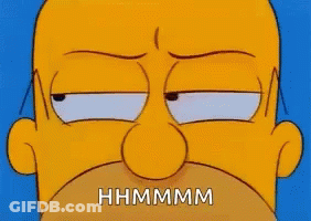 A Close Up Of Homer Simpson 'S Face With The Words `` Hhmmmm '' Written On It . GIF