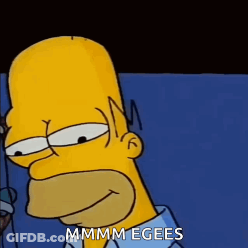A Close Up Of Homer Simpson 'S Face With The Words Mmmm Egees Written On The Bottom GIF