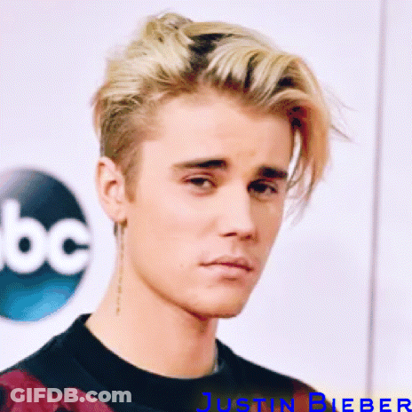 A Close Up Of Justin Bieber 'S Face In Front Of Abc GIF