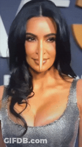 A Close Up Of Kim Kardashian 'S Face With A Pencil Sticking Out Of It GIF