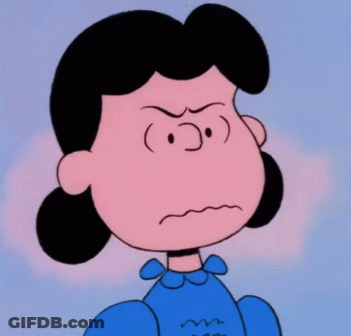 A Close Up Of Lucy Brown From The Peanuts Showing An Angry Look On Her Face GIF