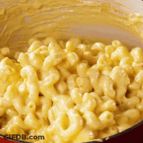A Close Up Of Macaroni And Cheese In A Red Pot GIF