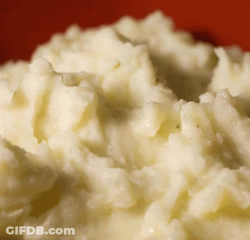 A Close Up Of Mashed Potatoes With A Red Background GIF