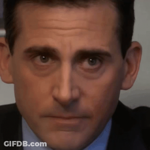 A Close Up Of Michael Scott 'S Face With A Serious Look On His Face GIF