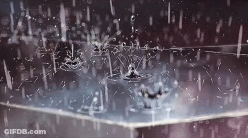 A Close Up Of Rain Drops Falling On A Table . GIF