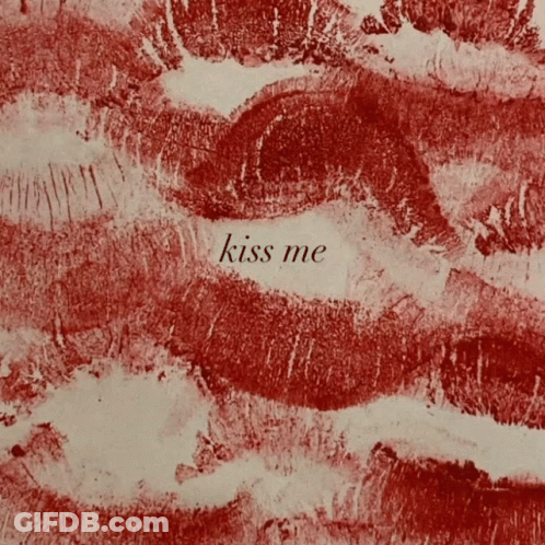 A Close Up Of Red Lips With The Words Kiss Me Written In White GIF