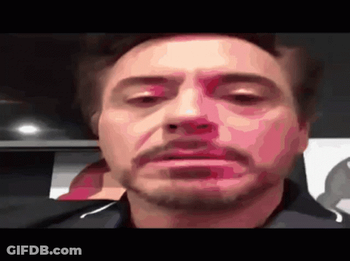 A Close Up Of Robert Downey Jr 'S Face With His Eyes Closed GIF