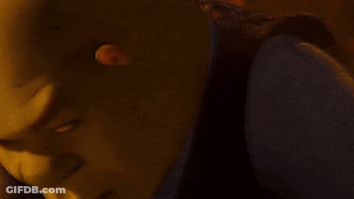 A Close Up Of Shrek 'S Face With A Yellow Background GIF