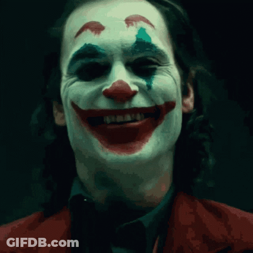 A Close Up Of The Face Of A Man Dressed As The Clown GIF