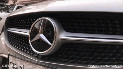 A Close Up Of The Front Of A Silver Mercedes Benz Car GIF