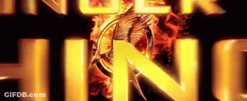 A Close Up Of The Hunger Games Logo With A Bird On It . GIF