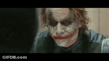 A Close Up Of The Joker 'S Face With A Fake Smile GIF