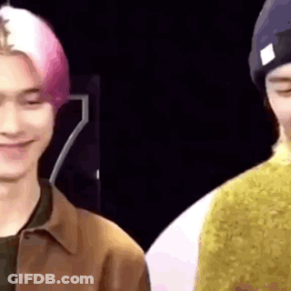 A Close Up Of Two Men Standing Next To Each Other And Smiling . GIF
