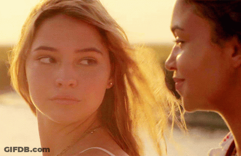 A Close Up Of Two Women Looking At Each Other With The Sun Shining On Their Faces GIF
