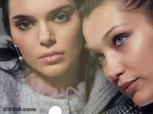 A Close Up Of Two Women 'S Faces With Their Eyes Closed . GIF