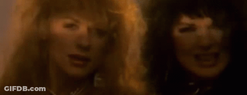 A Close Up Of Two Women With Their Mouths Open . GIF