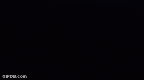 A Close Up Of Venom 'S Face With Sharp Teeth In The Dark . GIF