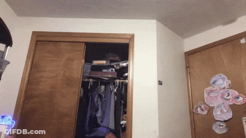 A Closet With Clothes Hanging And A Sticker On The Door That Says ' I Love You ' GIF