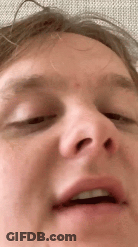 A Closeup Of A Man 'S Face With His Eyes Closed GIF