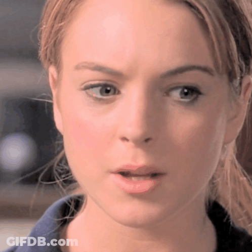 A Closeup Of A Woman 'S Face With Her Mouth Open GIF